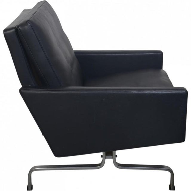 Poul Kjærholm PK31/2 chair upholstered in black aura leather, and with a frame of chromed spring steel. The chair is from...