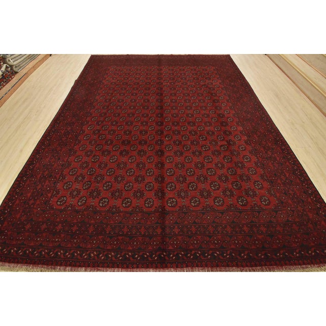 An authentic vintage tribal Turkmen rug hand-knotted with fine wool and natural dyes. This nomadic oriental rug features...