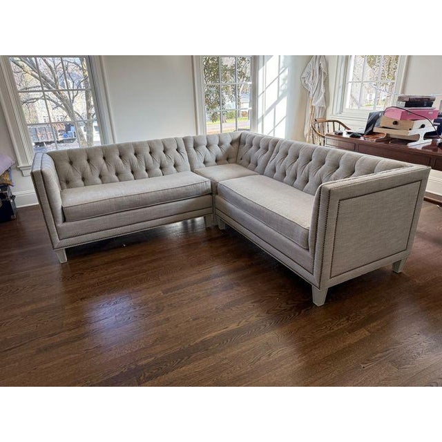 Great sized sectional upholstered in dove gray performance fabric. Design features a tufted back, painted wood feet, and...