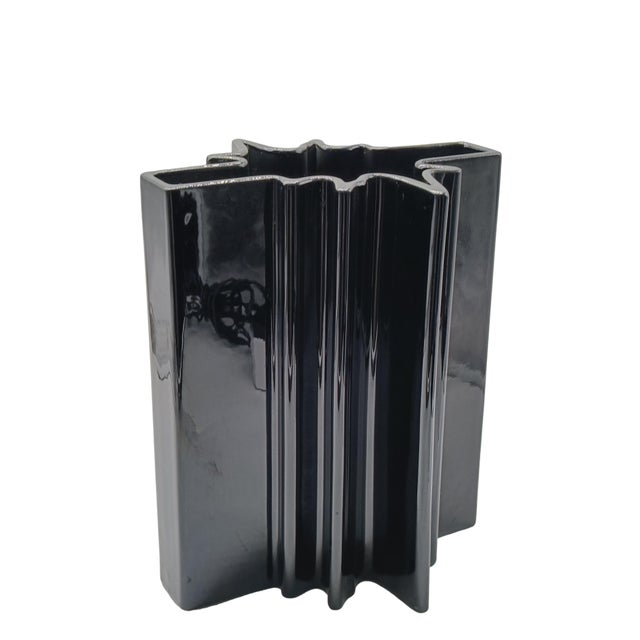A sculptural vase in glossy black glazed ceramic, designed by the renowned architect and designer Angelo Mangiarotti...