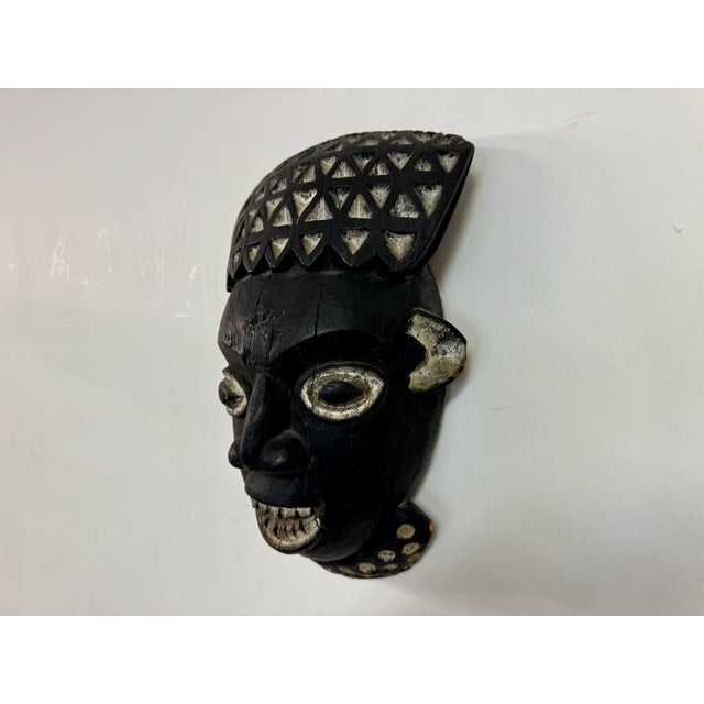 This African mask is characterized by its bold and intricate design, reflecting traditional craftsmanship and cultural...