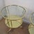 Solid brass two-tier round side tables with glass tops. The glass tops are recessed and flush with the frame providing a...