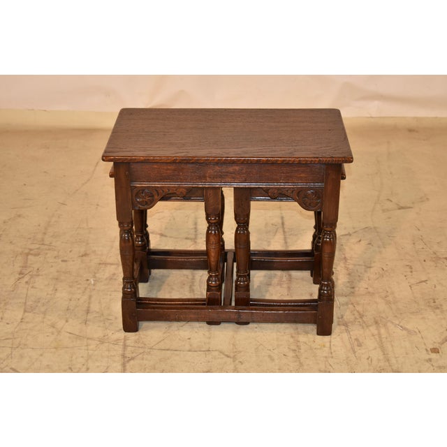 English oak nest of three tables made from oak. The tops are nicely grained and follow down to simple aprons, with small...
