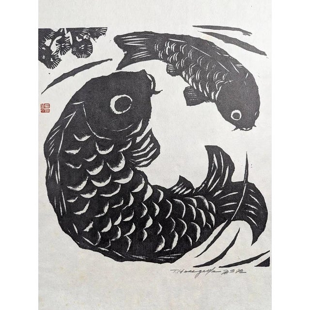 A striking original Japanese woodblock print by Tomisaburo Hasegawa, featuring two koi fish in a dynamic, circular...