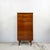 A tall, narrow chest of six drawers by Austinsuite, finished in teak veneer with a fine straight grain. It's a good fit...