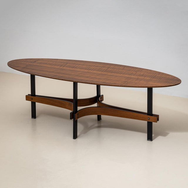 A pair of elegant coffee tables in teakwood, attributed to Guglielmo Ulrich, dating to the 1950s. The elongated oval...