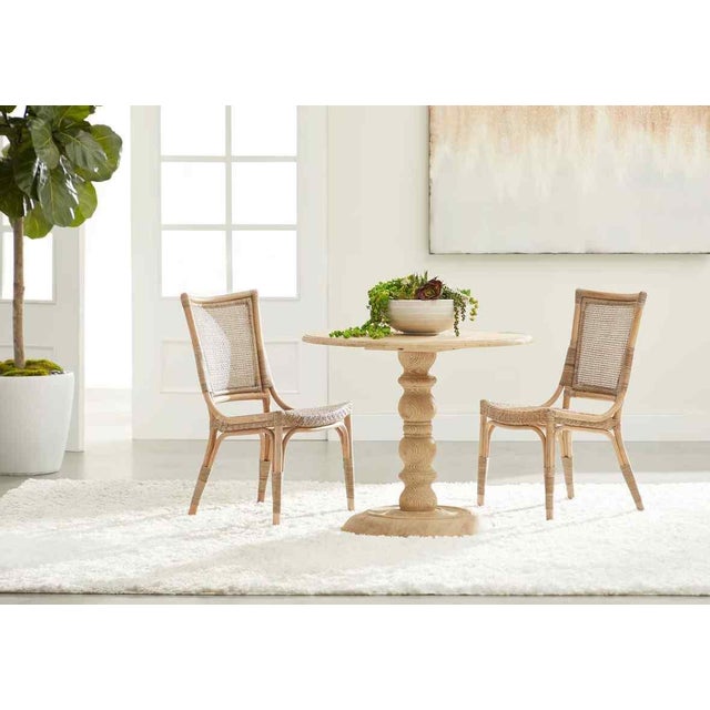 Functional seating meets artisan craftsmanship in the Luna Rattan Frame Armless Dining Chair 2PC. This set of two dining...