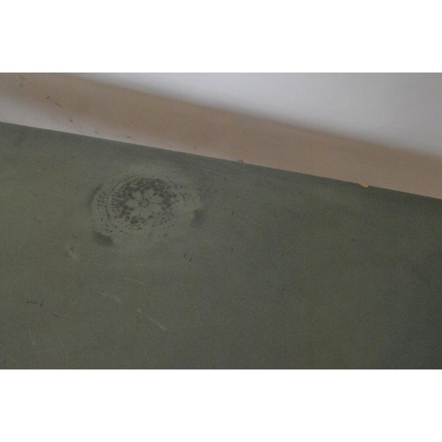 Large table or office 'spazio' on the tray covered with green vinyl, resting on a gray and black metal base. The feet end...