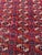 Vintage Afghan Turkmen Bokhara rug, hand-knotted in Afghanistan from 100% wool. Measuring 5’3” x 7’11”, the rug features a...