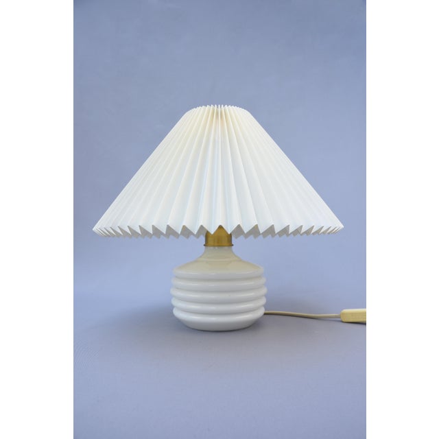 A beautifully preserved model 313 "krone" table lamp produced by le klint, denmark, during the 1950s. Combining an elegant...