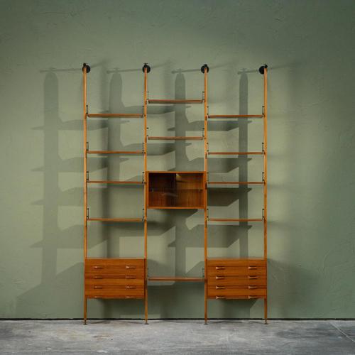 This Italian wall unit from the 1960s is made from teak with brass elements and includes two drawer cabinets and one...