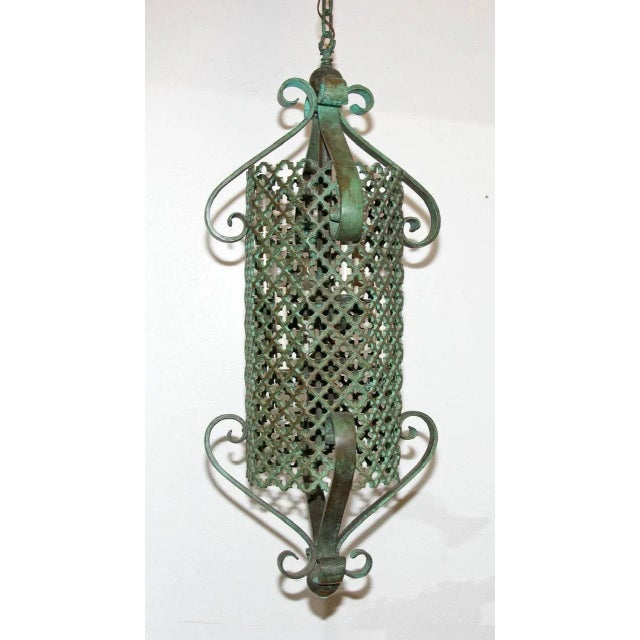 High quality bronze pendant light. Verdigris patina. Interior with six candle lights and one down light. Six feet of...