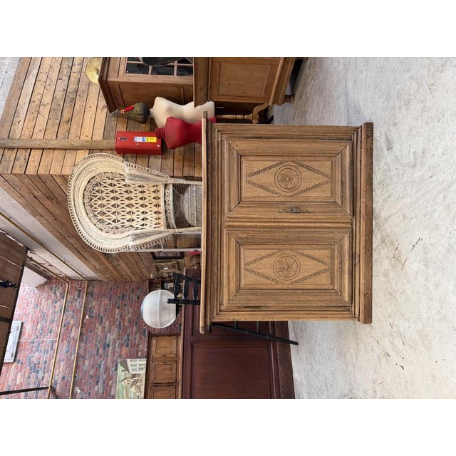 This sideboard has been completely restored. It features two carved doors that open to reveal storage space. There is a...