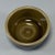 This vintage‑style celadon tea bowl is covered with glossy dark‑toned glaze. Its outer wall is decorated with neat slanted...