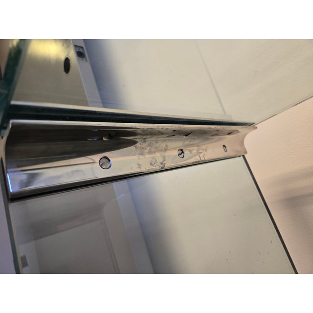 The Pace Collection Glass Waterfall End Table is a striking example of minimalist design and craftsmanship. Made from a...