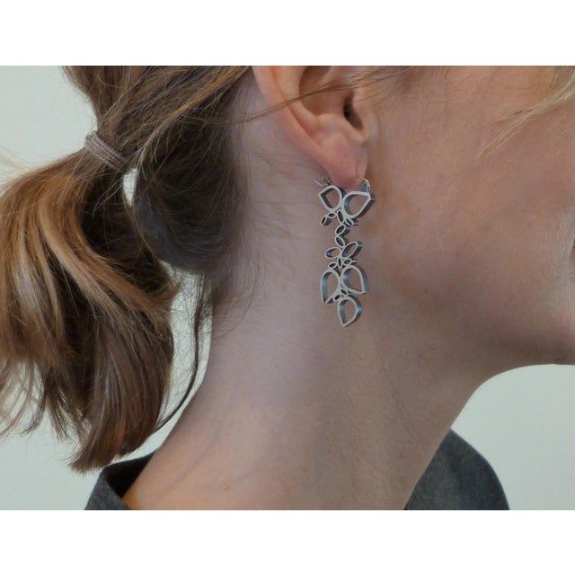 These earrings were hand-fabricated in sterling silver by Baltimore artist Hilary Hachey. Each avocado shape is hand-...