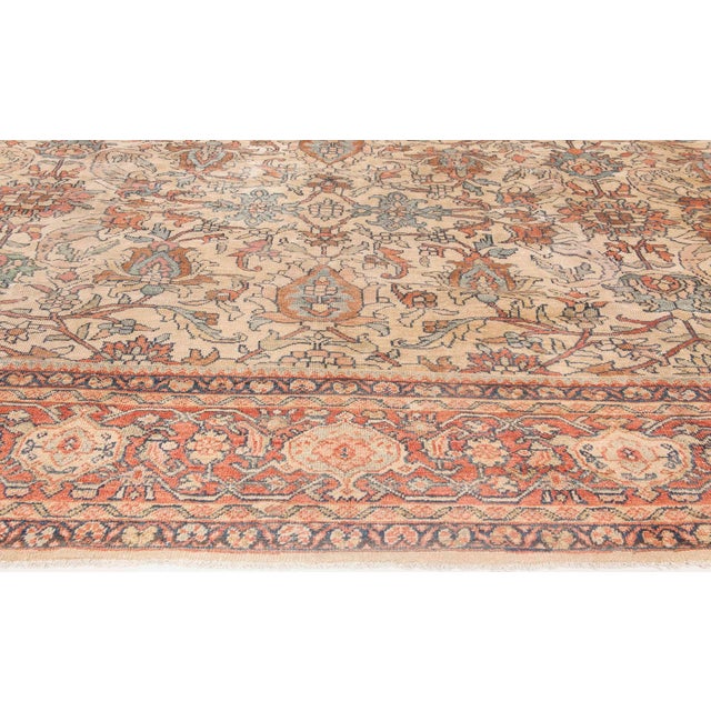 A late 19th century Persian Sultanabad carpet, the caramel field with a stylized palmette, leafy vinery and flowerhead...