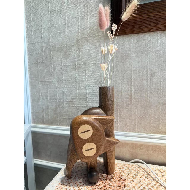 This delightful hand-carved solid ebony wood cat bud vase is crafted around the adorable pose of a startled, puffy-tailed...