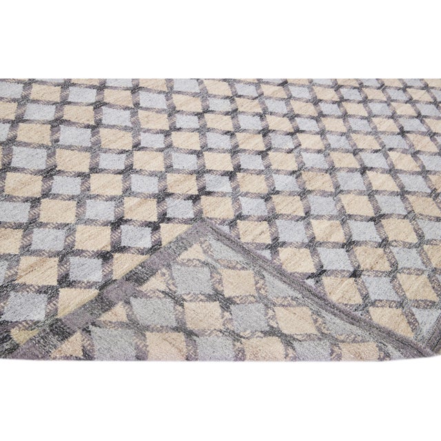 Beautiful modern Swedish-style wool rug with a gray field. This piece has beige and purple accents featuring a gorgeous...