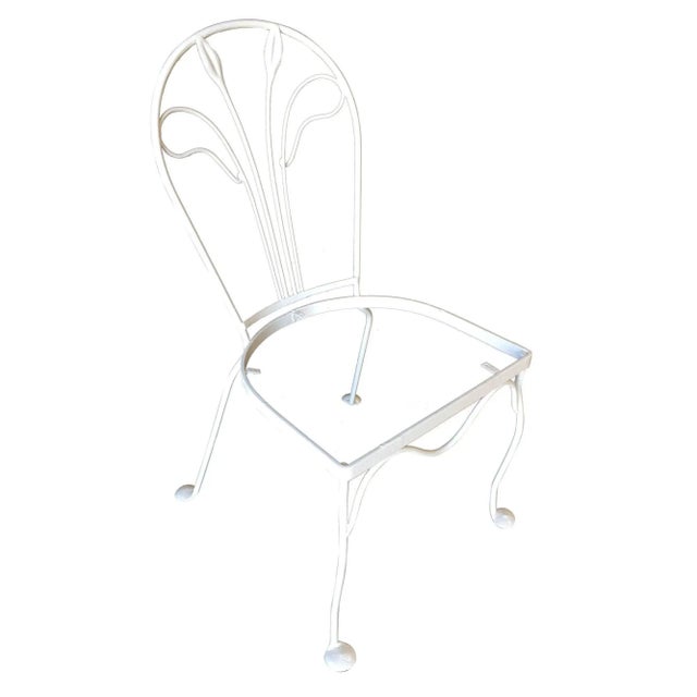 A set of four Salterini rod iron outdoor/patio chair with a distinct tropical leaf backrest. This chair is constructed...