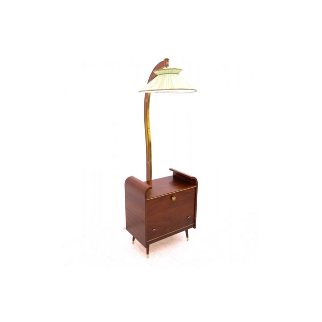 A unique bar cabinet with an integrated lamp, dating back to the 1970s. This piece combines functionality with the elegant...