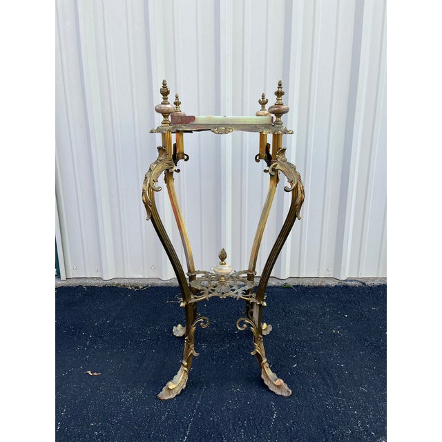 A stunning work of art. This brass player stand features a dichotomy of polished brass with a beautifully figured onyx top...