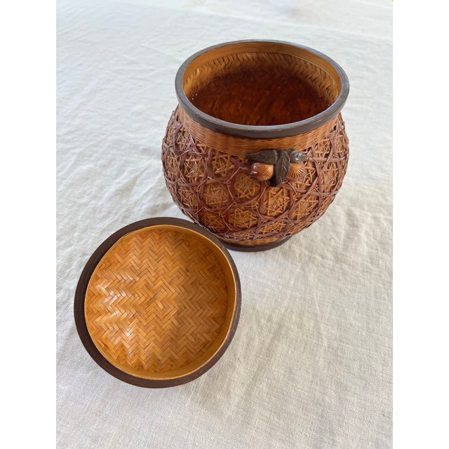 Vintage Chinese ginger jar made of woven bamboo and rattan with decorative wooden elements. Great catchall or as a vase...