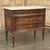 19th Century French Louis XVI Walnut Commode was hand-crafted from select French walnut, and features timeless...