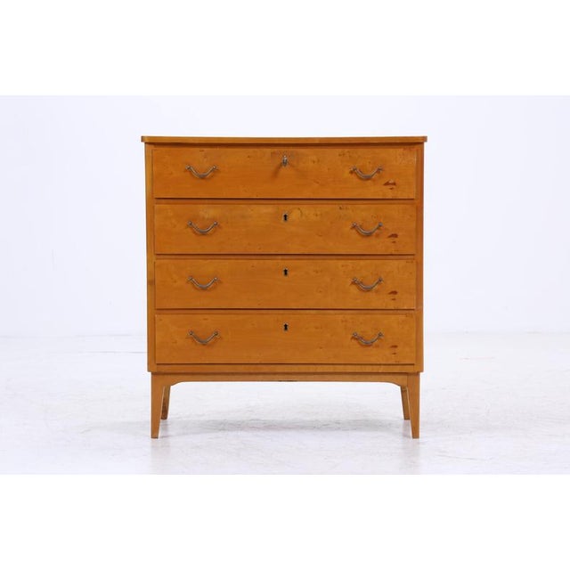Beautiful mid-century chest of drawers from the 1960s • High-quality workmanship • 1 key • 4 drawers • Material: Wood...