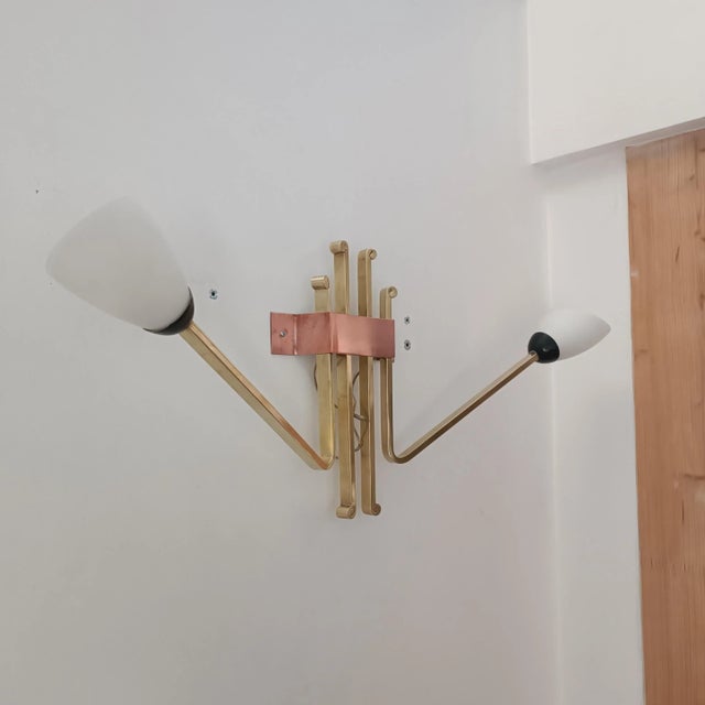 Magnificent wall sconce in the style of Arlus, Lunel. 1960s. Brass and copper structure. It holds two beautiful white...