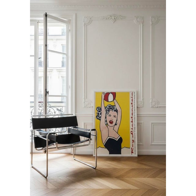 A stunning print of Girl with Ball (1961) by Roy Lichtenstein, a true icon of pop art. This vibrant and bold piece...