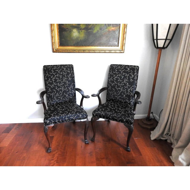 Antique carved walnut side chairs with arm rests. Georgian style with shell and ho ho bird motif. The chairs were...