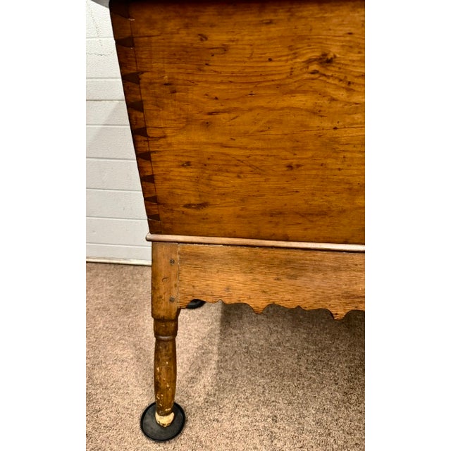 Nice 19th century pine dough box raised on turned legs and with a removeable top. One of the details I like about this is...