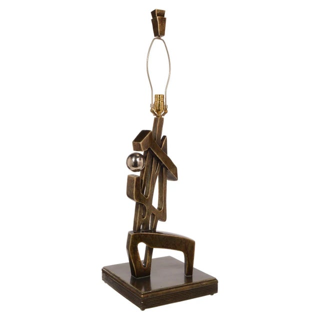 This tall and impressive Modernist table lamp looks like a real abstract sculpture. The finish looks like a silver bronze...