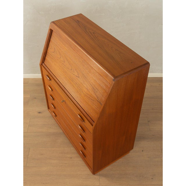 Classic secretary desk from the 1980s. High-quality solid teak frame with four drawers, a pull-out work surface, five...