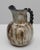20th Century Belgian ceramic vase. This expressive vase features a bulbous form with a wide flared rim and a twisted black...