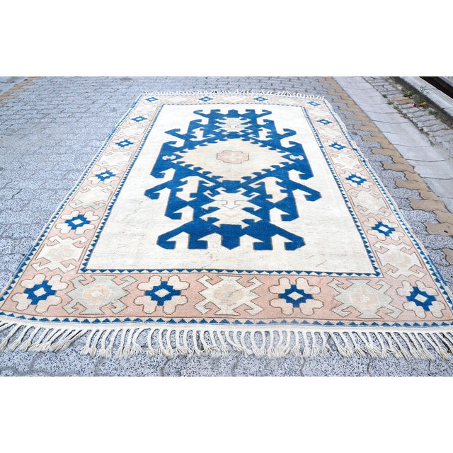 This is a vintage Turkish Oushak rug from the 1960s. The piece was hand-knotted