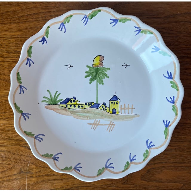 This charming pair of hand-painted Quimper style scallop edge plates or shallow bowls feature French scenes as shown. Made...
