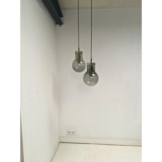 This set of 2 Maxi Bulb pendants was designed and made by Raak Amsterdam in 1965. The shape of the pendant refers to the...