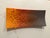 15 1/4 L x 6 3/4 W one-of-a-kind glass platter from artist Robin Kittleson, featuring an ombre orange color with blue and...