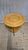 A charming vintage wooden coffee table featuring a round tabletop, a sculptural curved-leg base, and a circular lower...