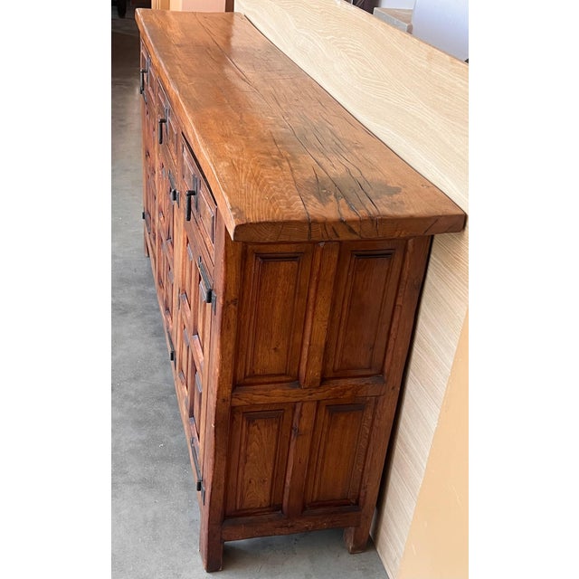 From Northern Spain, constructed of solid oak, the rectangular top with molded edge atop a conforming case housing three...