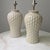 A pair of 1980's vintage ceramic ginger jar lamps. The lamps feature basket-weave relief and speckle glaze finish....