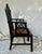 A Chinese Chippendale style ebonized armchair with a double hand caned seat. Hand carved frame of Philippine mahogany with...