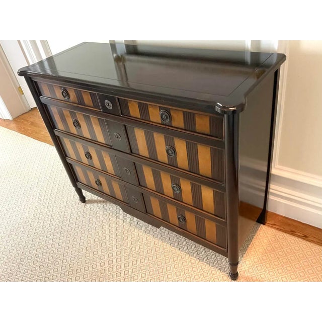 Regency style occasional walnut and satinwood chest of drawers with a scored top with beveled edge and rounded corners...