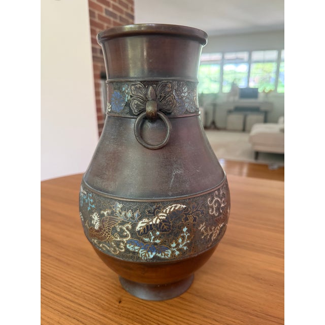 A striking example of Meiji-period Japanese metalwork, this bronze hu-form vase marries the weight and gravitas of ancient...