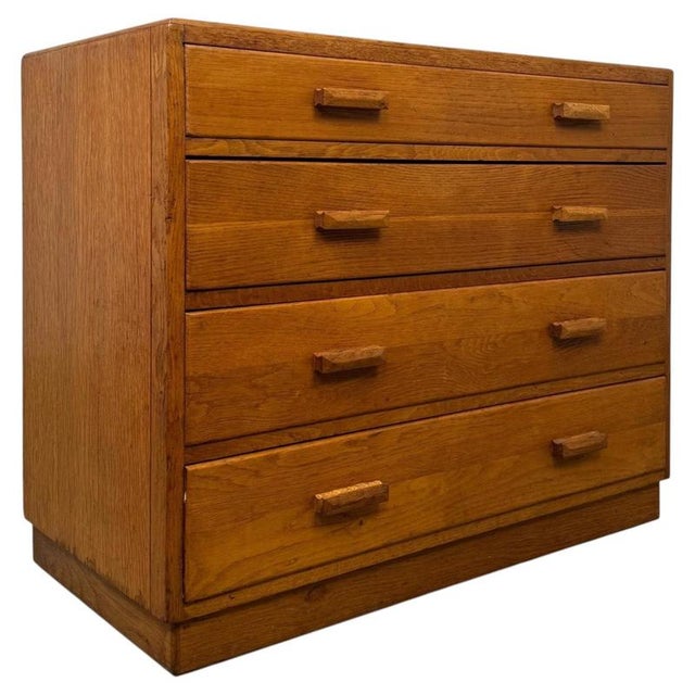 A handsome and well-crafted early 20th-century English chest of drawers, beautifully constructed in golden oak and...