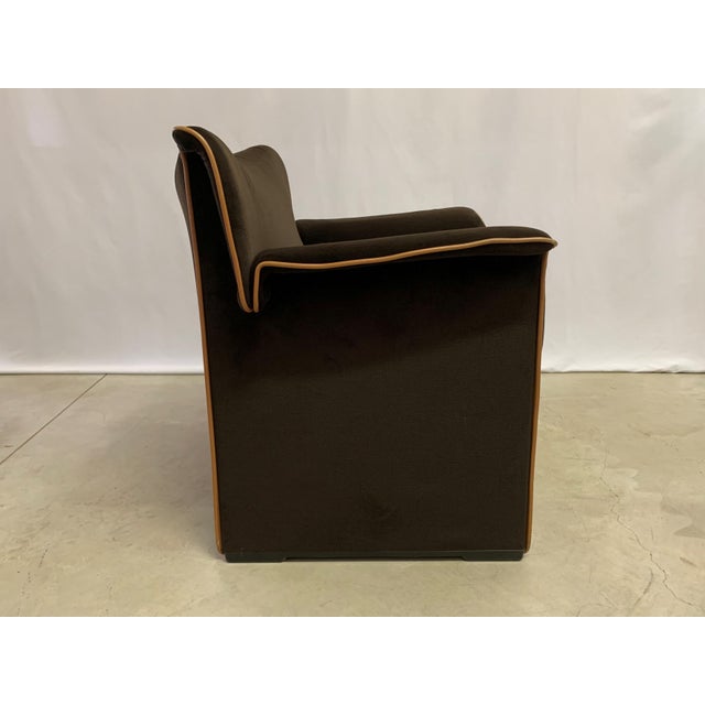 The Lauriana features a soft, enveloping silhouette, defined by rounded armrests and a high, slightly flared backrest that...