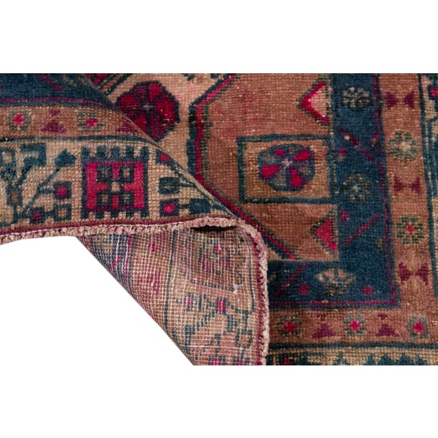 Beautiful Vintage Shabby Chic hand-knotted wool rug with a pink field. This Scatter rug has accents of beige and blue all-...