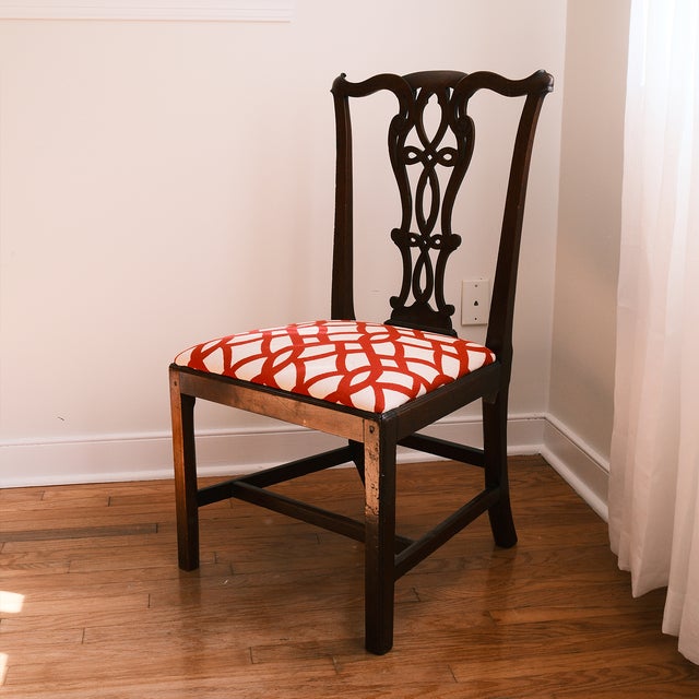 A characterful Chippendale style side chair with an elaborate openwork back, scrolling details, a shaped crest rail, and a...